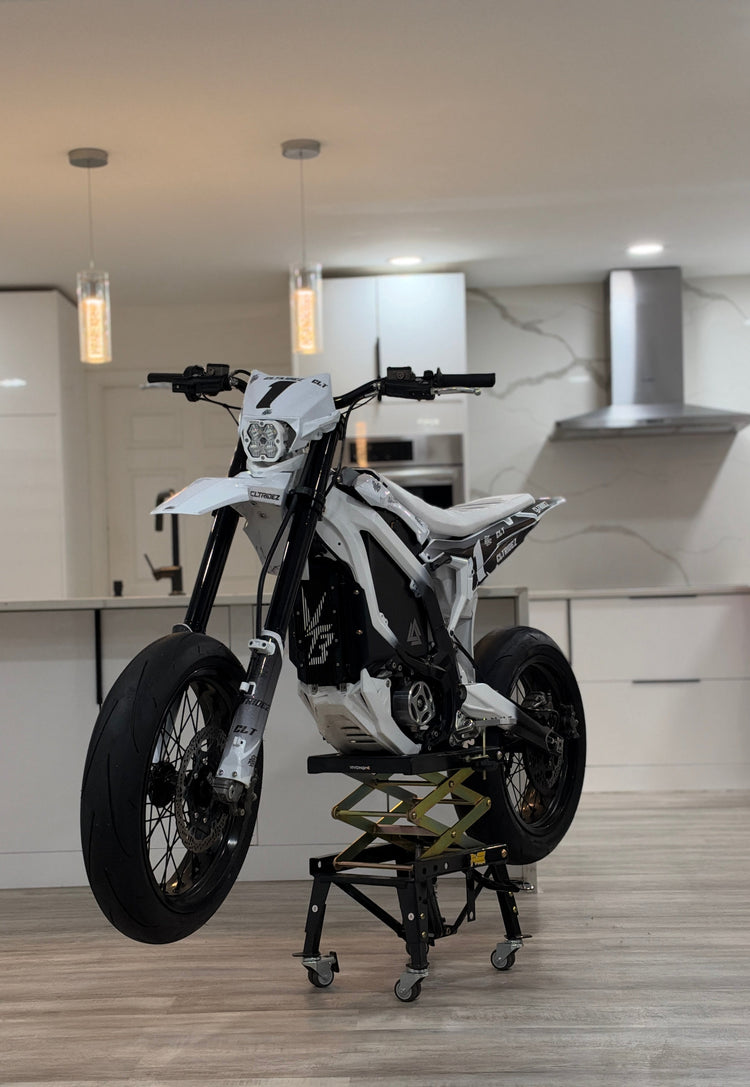 White Surron supermoto build on a lift stand