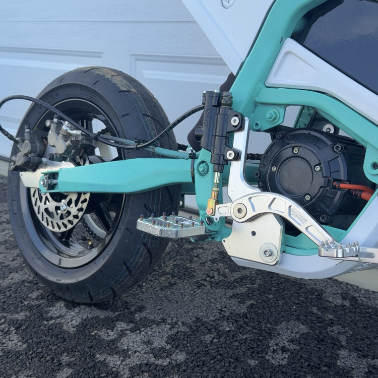 Footbrake and peg detail on a custom e-moto