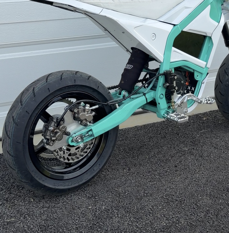 Rear wheel and swingarm detail on a custom e-moto